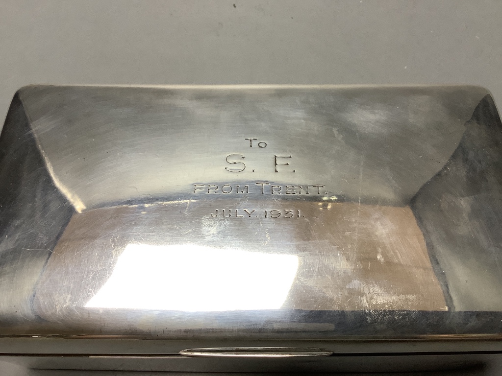 A 1930s silver rectangular cigarette box with engraved inscription.